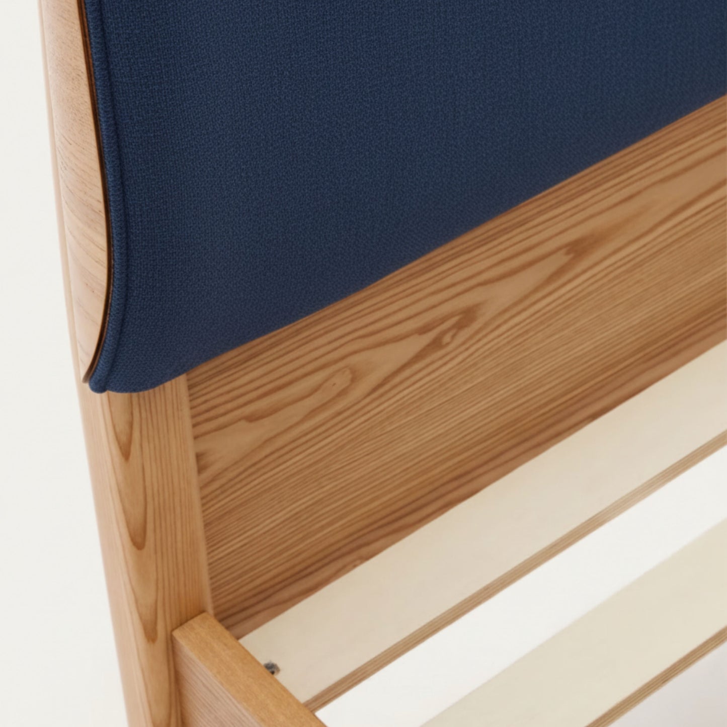 Close-up of AR4HandsFurniture Serenity bed's luxe chenille headboard texture and natural ash wood grain details.