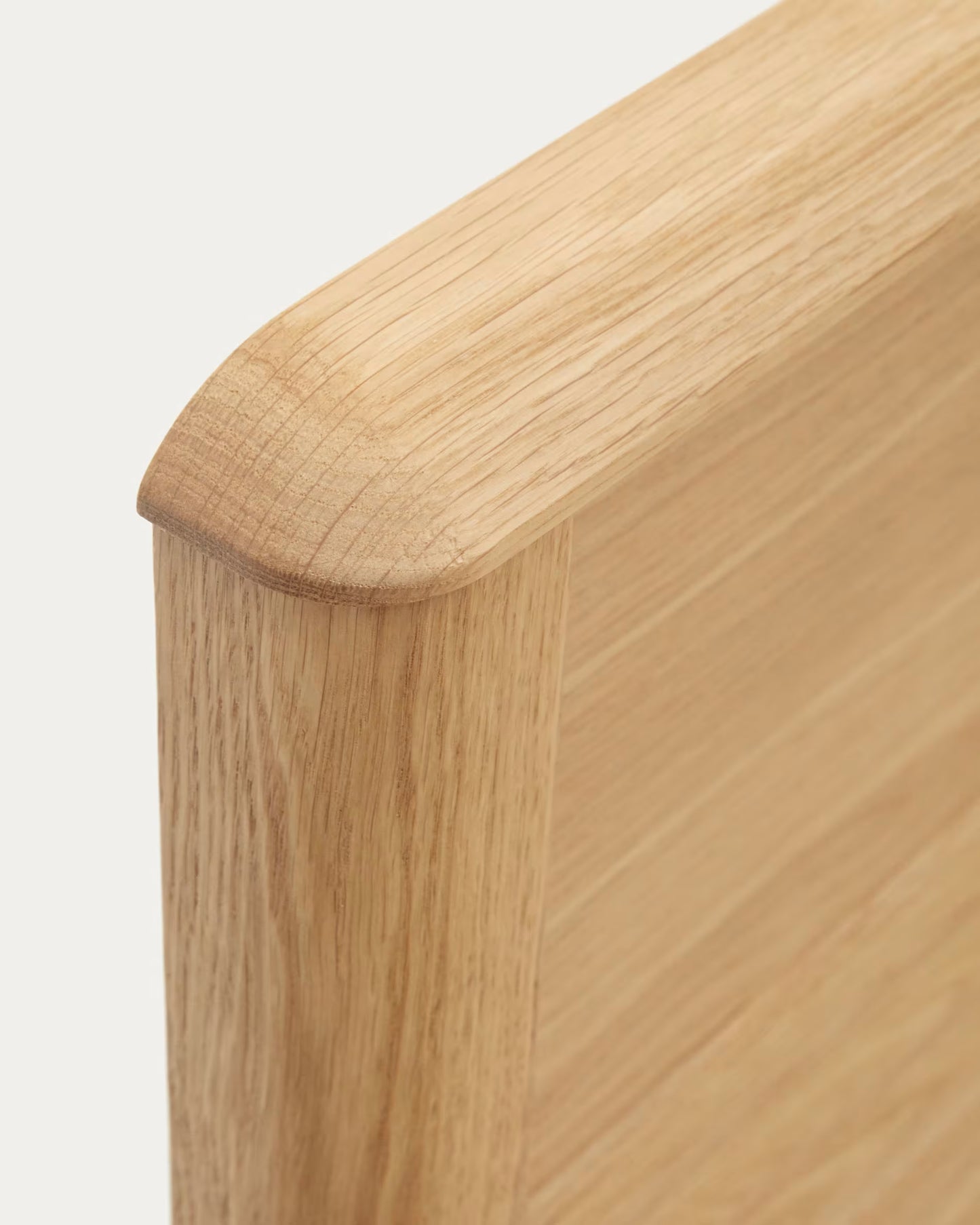Close-up of the carved headboard with soft rounded edges