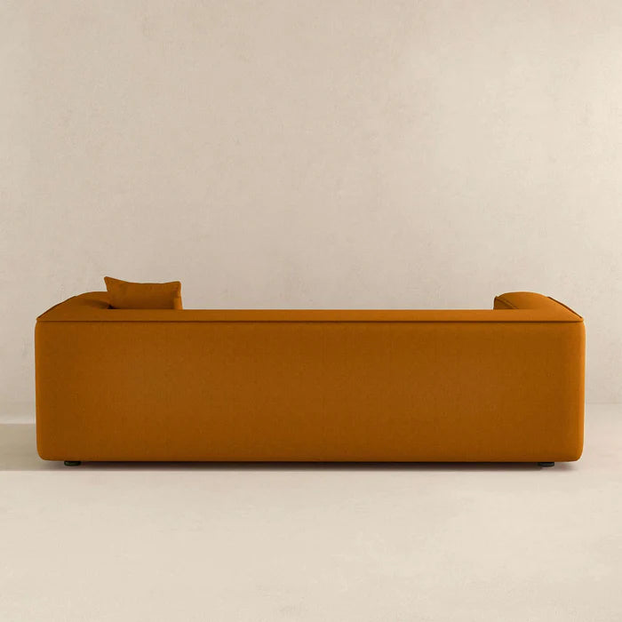 The Sukun Boucle Sofa by AR4HandsFurniture. A back view of the modern, dark yellow sofa.