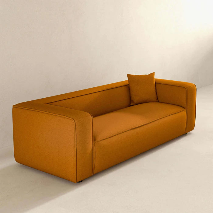 Side profile of The Sukun Sofa, highlighting the soft French Boucle fabric and elegant design.