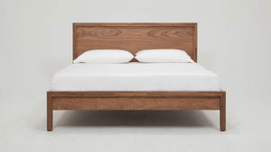 A close-up of the premium Walnut veneer and the smooth, eco-friendly finish on the bed frame."
