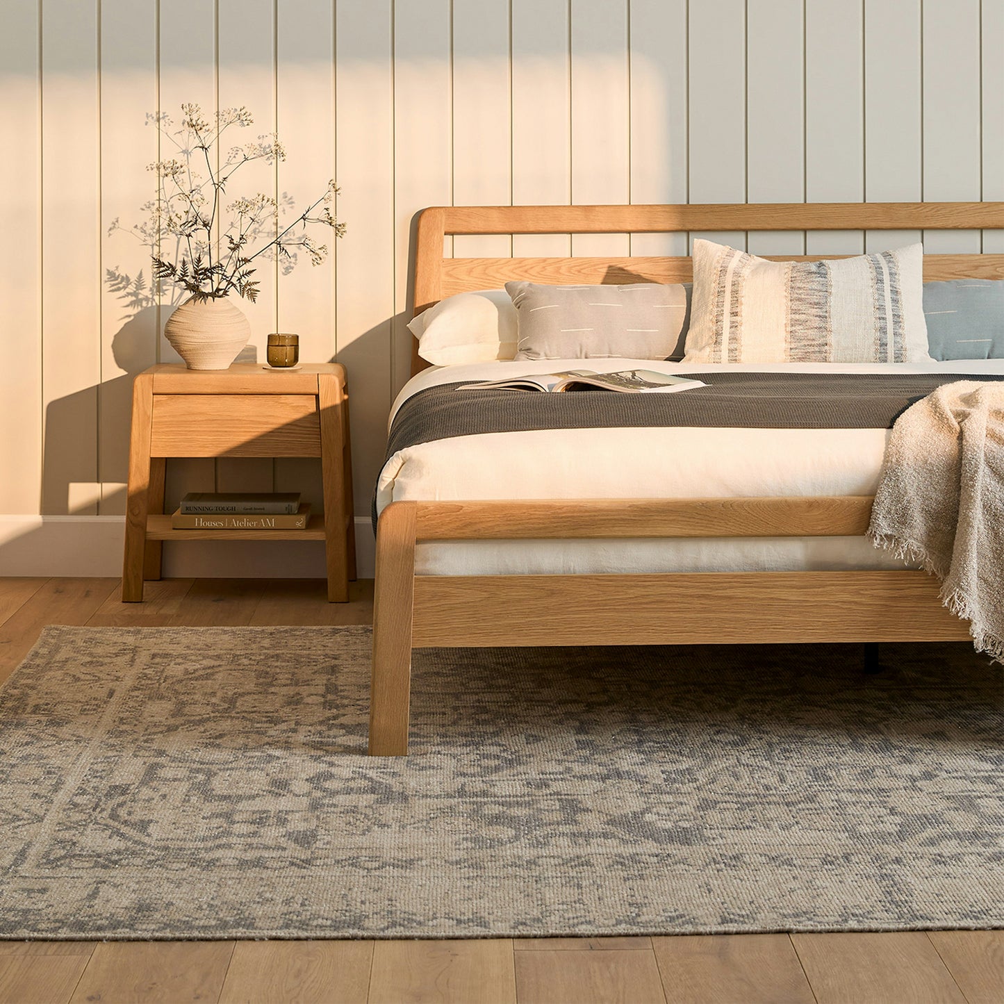 The Zen Oak Bed as a centerpiece in a spacious, naturally lit bedroom with minimalist decor."