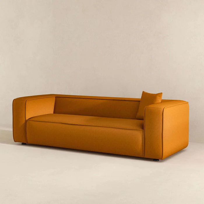 A side close-up of the textured French Boucle fabric and intricate stitching on The Sukun Sofa."