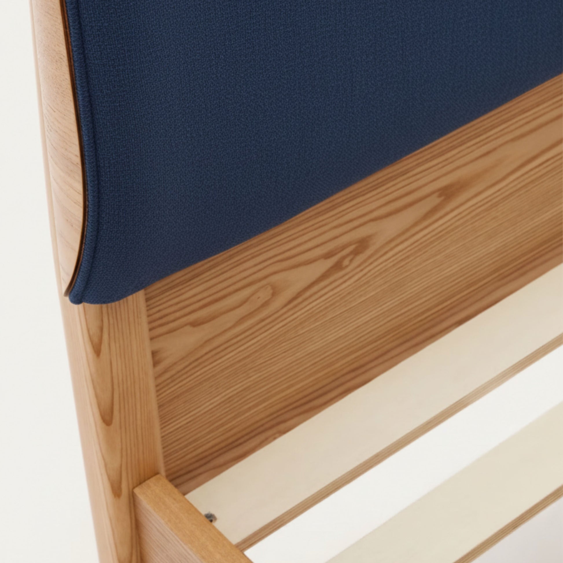 Close-up of AR4HandsFurniture Serenity bed's luxe chenille headboard texture and natural ash wood grain details.