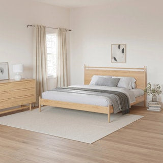 Side view of The Legacy Panel Bed, showcasing the low-profile frame and elegant tapered legs