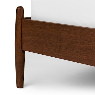 The Legacy Panel Bed Wooden headboard corner on a white background