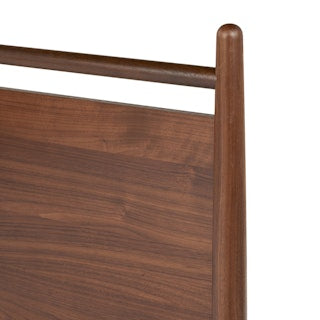 TheLegacyPanelBed_ Close-up of a wooden headboard with a white background
