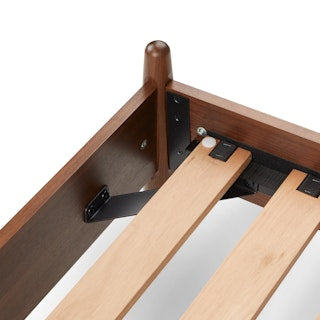TheLegacyPanelBed_ Wooden bed frame with metal brackets on a white background