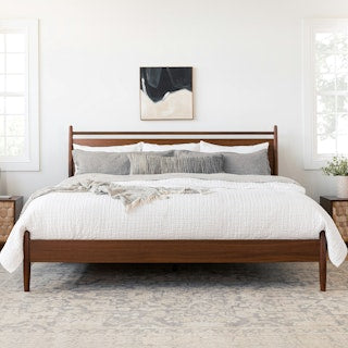 The Legacy Panel Bed by AR4HandsFurniture. A modern, minimalist walnut wood bed with a clean design and panel headboard."