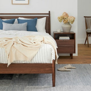 TheLegacyPanelBed Bedroom with wooden bed, nightstand, and decor 