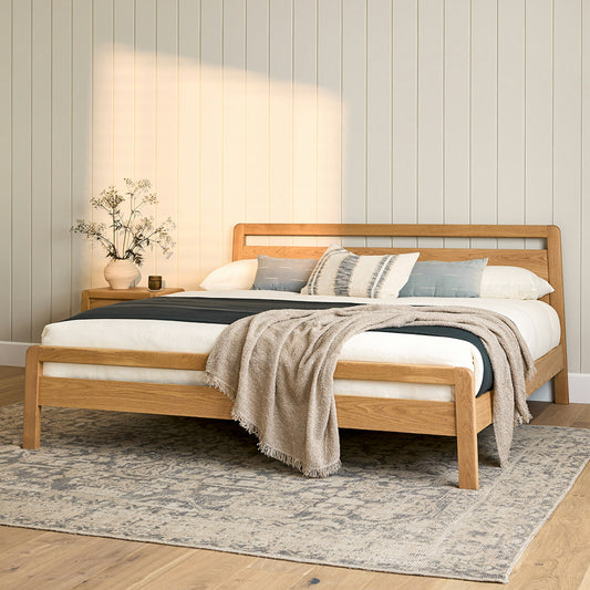 "The Zen Oak Bed by AR4HandsFurniture. A minimalist, Scandinavian-inspired bed with a natural oak finish and slanted legs."