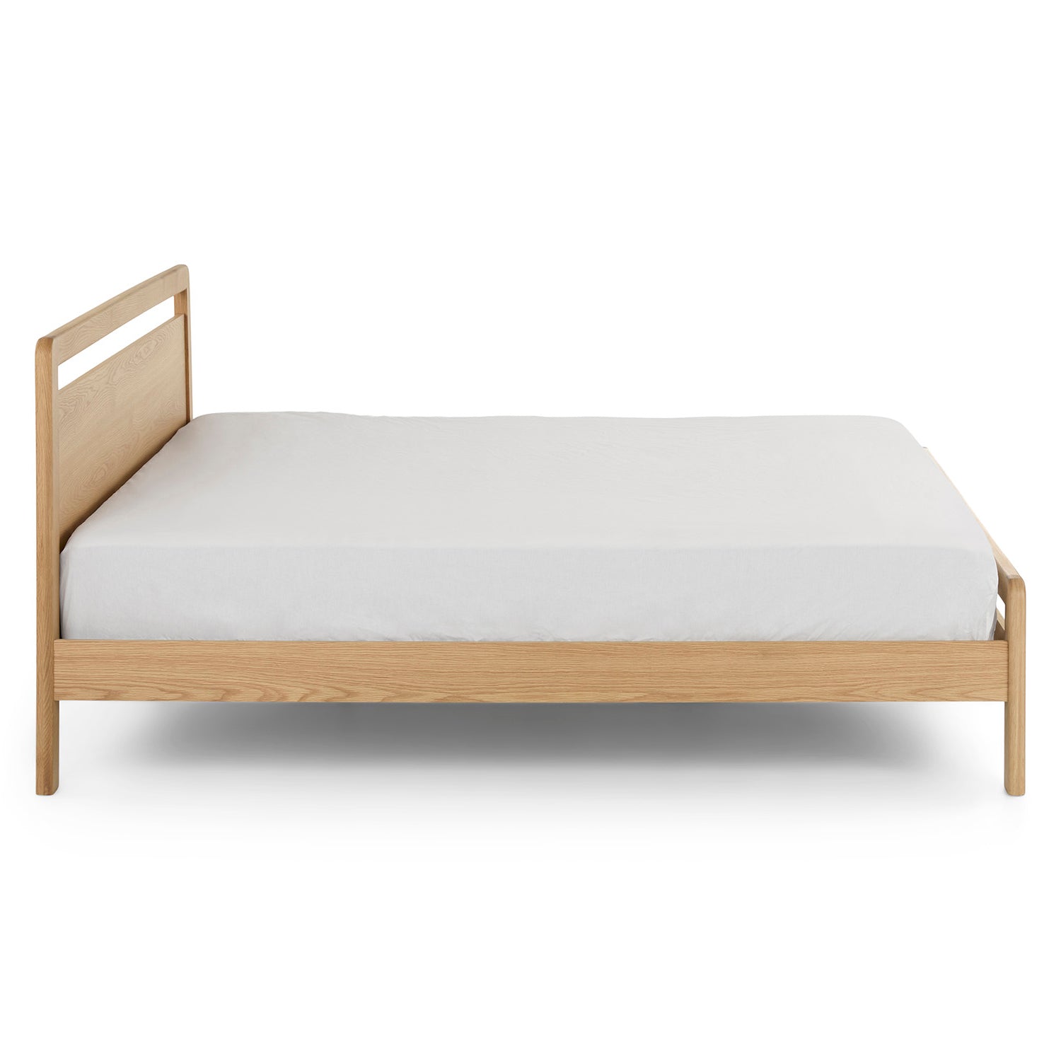 Side view of The Zen Oak Bed, showcasing its low-profile design and elegant lines."