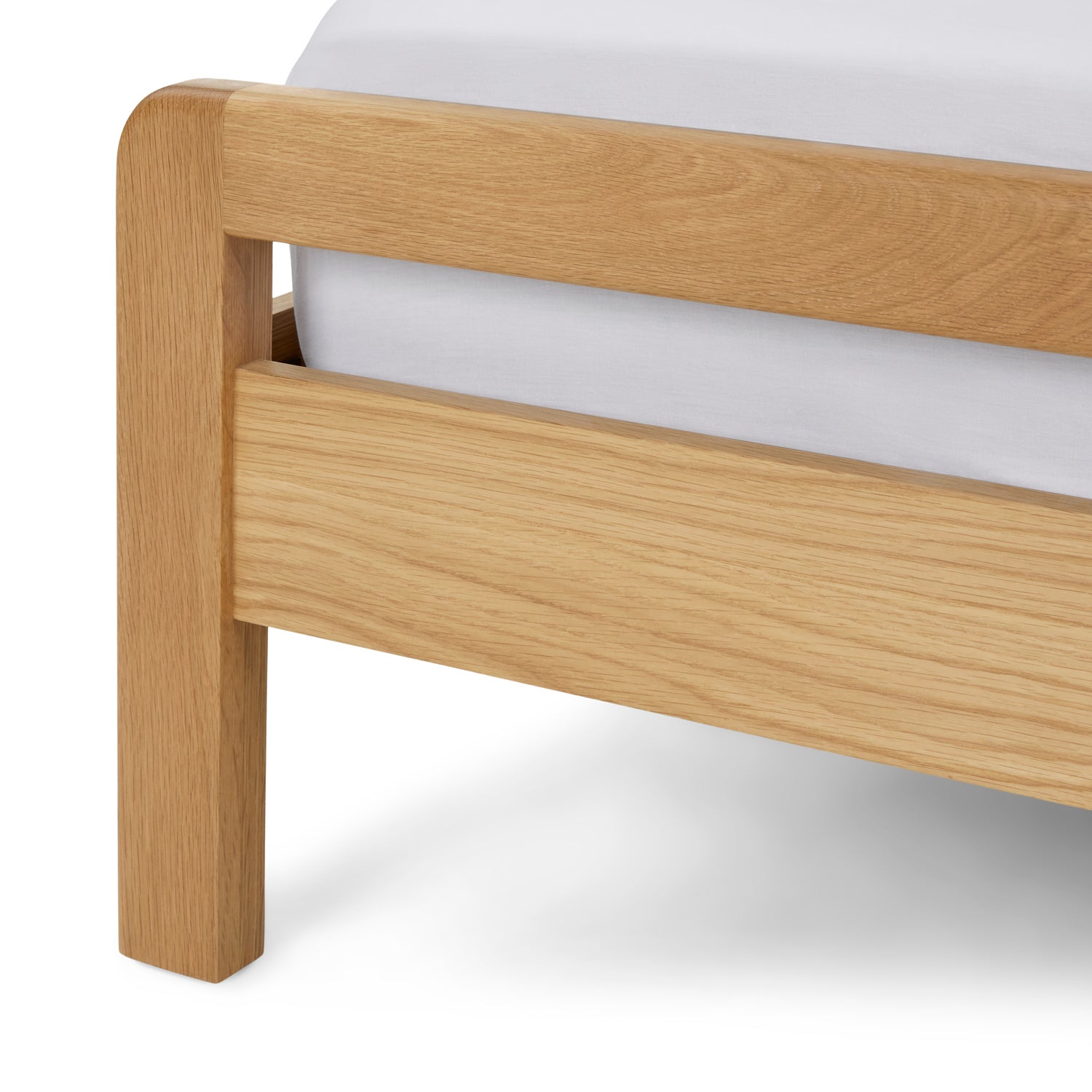 Detail shot of the bed's slanted legs, emphasizing the unique artisanal cutouts and solid wood construction."