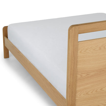 Close-up of the solid oak headboard of The Zen Oak Bed, highlighting the natural wood grain and serene design."